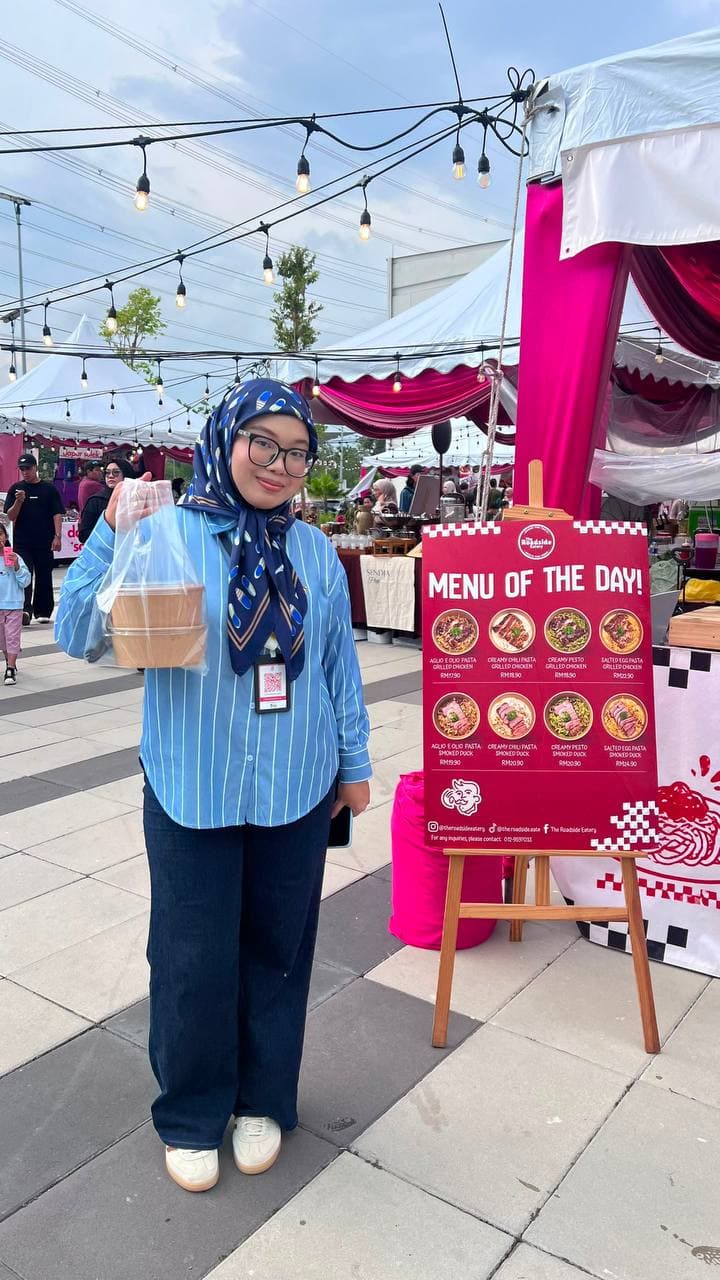 A guest with her takeaway order at a Roadside Eatery pop-up